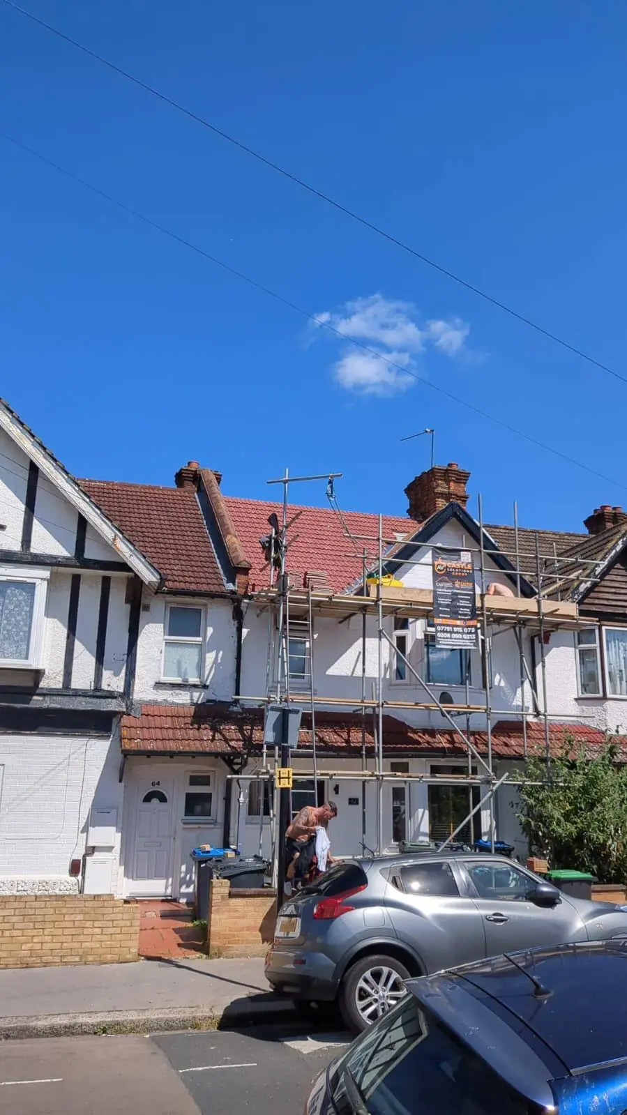 Scaffolded semi-detached house on a suburban street