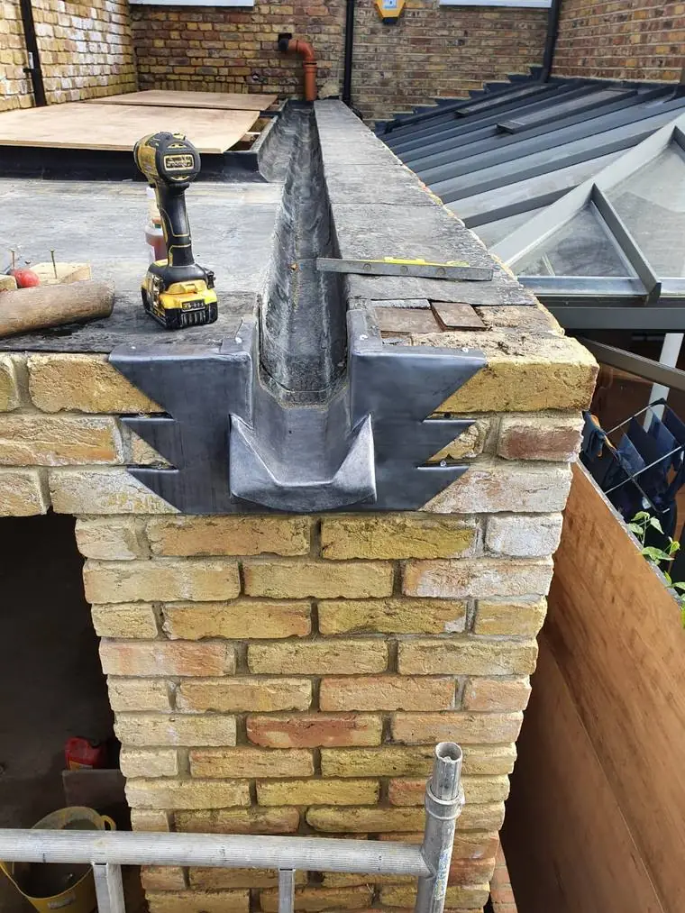 Chimney brickwork being rebuilt with new lead