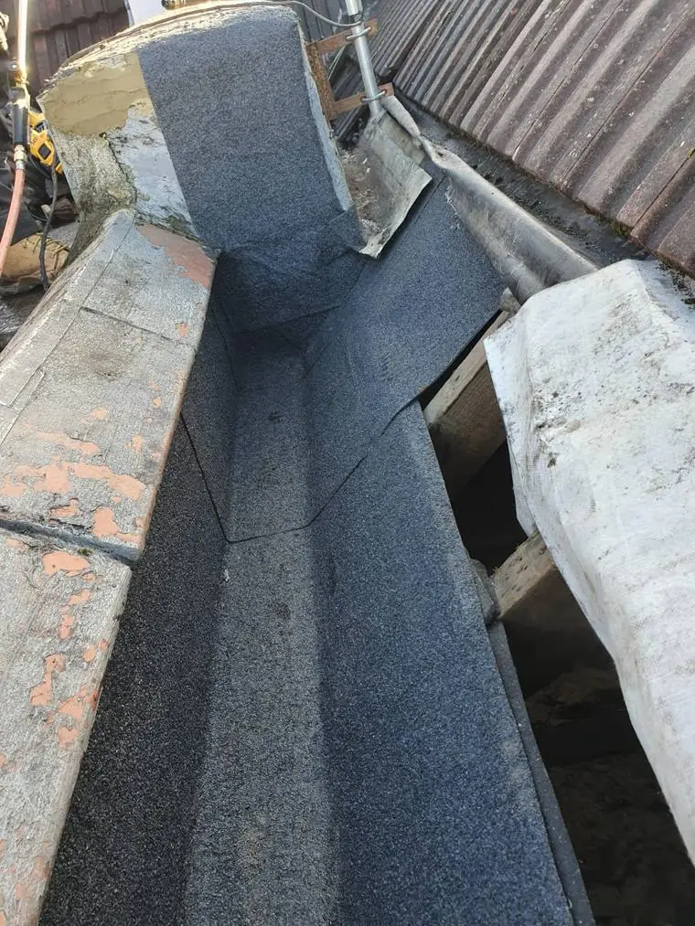 Box gutter stripped and re-felted between roofs