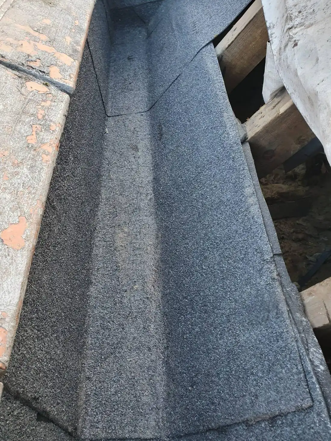 A finished felt gutter detail, edges dressed